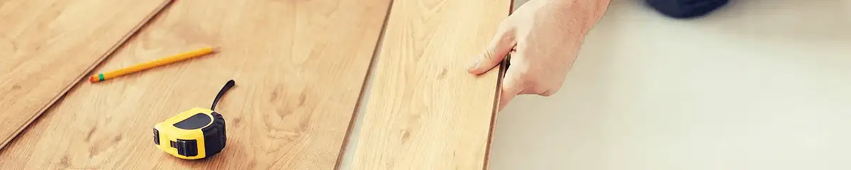 A professional installing wood flooring in Cedar Rapids, IA