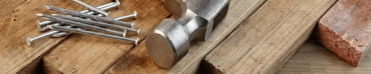 Hammer and nails on hardwood flooring boards in Cedar Rapids, IA