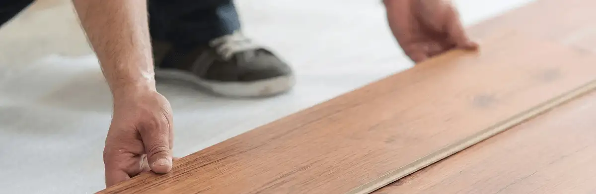 A professional installing laminate flooring in Cedar Rapids, IA