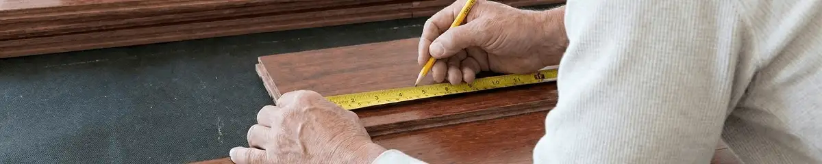 A professional installing wood flooring in Cedar Rapids, IA